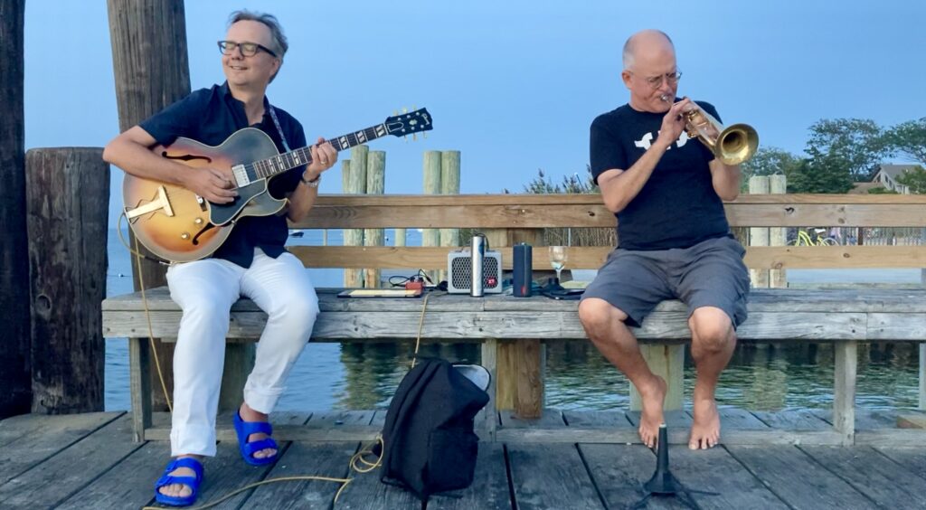 Chester Jankowski and John Turner playing on the Fair Harbor Dock, Fire Island, August 2022.